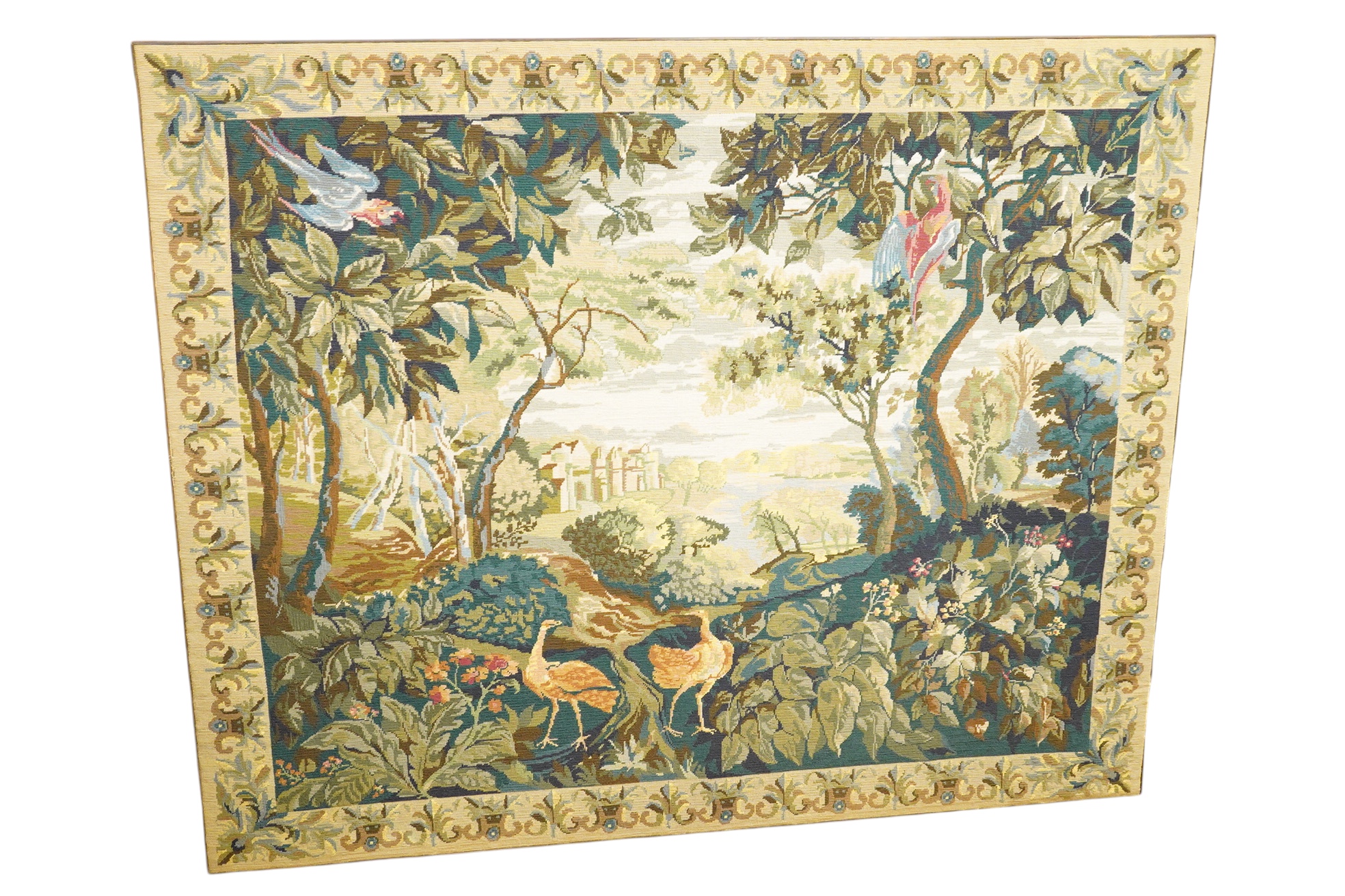 A large framed gross point wool work panel, designed in a verdure foliate palette as a classical French landscape. 161cm wide x 132 cm high.